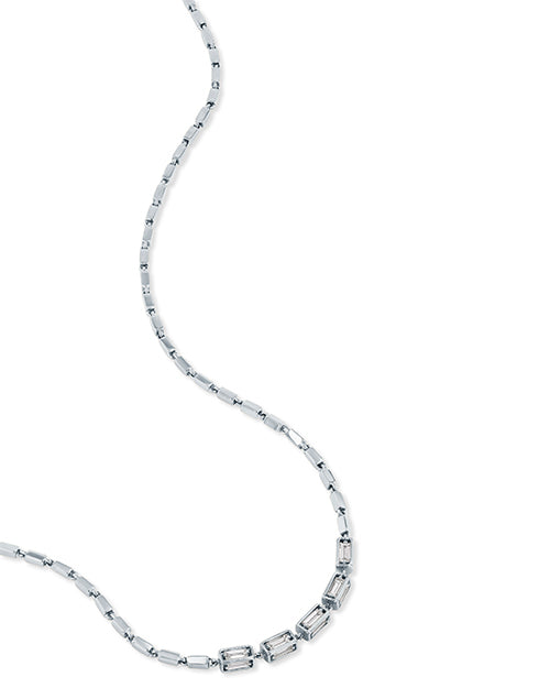 Half of a silver chain necklace with a pattern of small, rectangular links. The 5 links in the center are slightly larger than the others, with jewels in the center. The background is plain white.