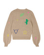The backside of a beige crewneck sweater with puffy sleeves, and colorful western cowboy paraphernalia scattered across it. The inner neckline has a white square tag reading "JUMPER 1 2 3 4". The background is white.