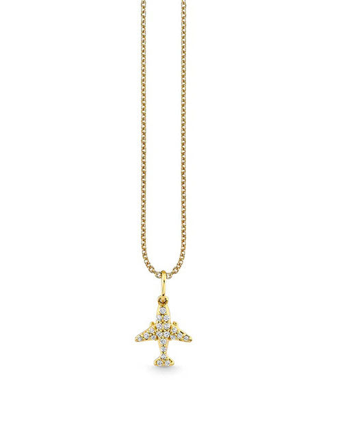 A gold chain necklace with a gold airplane pendant adorned with jewels. The background is plain white.