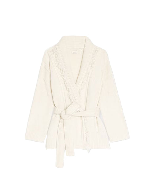White knitted cardigan with a shawl collar, fringe detailing along the edges, long sleeves, and a matching waist tie.