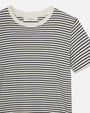 A closeup frontal view of a short-sleeved, crew-neck t-shirt with horizontal black and white stripes and a white neckline against a white background. There is a tag inside the neckline which reads "FRAME".