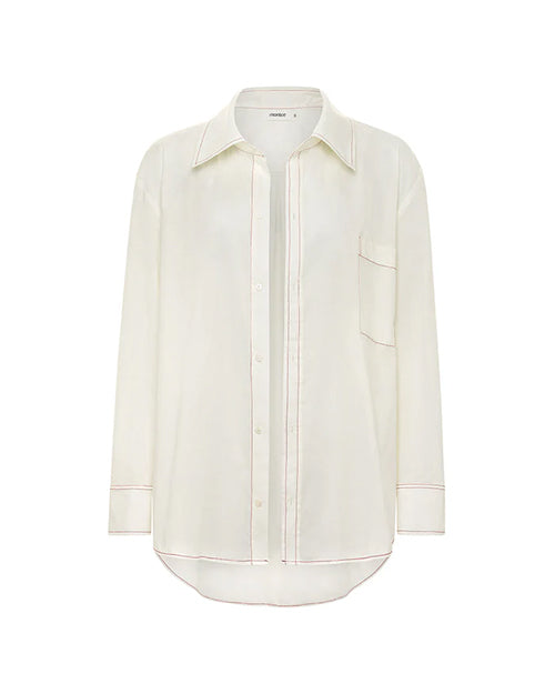 A long-sleeved, button-up shirt with a collar and visible red stitching. The shirt is placed against a white background.