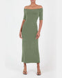 A body shot of a model wearing a green off the shoulder midi dress with short sleeves, and black flip flops to match. The background is plain white.