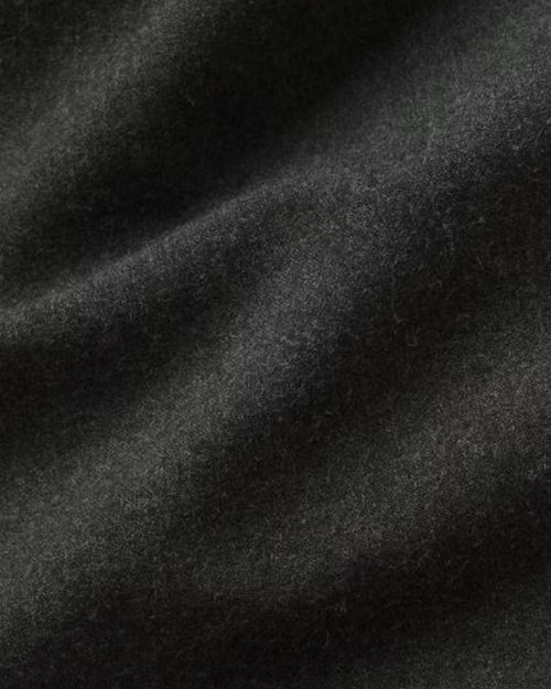 A close-up image of soft dark green fabric.