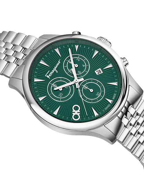 Close up of a Salvatore Ferragamo watch with green face and silver metal strap on white background