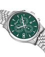 Close up of a Salvatore Ferragamo watch with green face and silver metal strap on white background