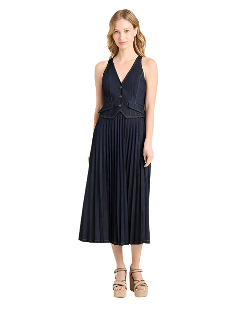 Woman wearing a navy dress with a buttoned bodice, paired with platform sandals on a light  background