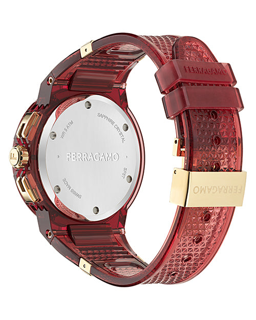 A backside view of a sporty red transparent wristwatch with a round silver case back engraved with "FERRAGAMO" at the center, along with "SWISS MADE," "SAPPHIRE CRYSTAL," and "5 ATM." The strap has a textured pattern and gold-tone accents, including a clasp with the Ferragamo logo. The background is plain white.