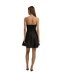 A full body view of a model wearing a strapless black dress that flares out at the bottom. The model is also wearing black pointed-toe shoes and standing against a plain white background.
