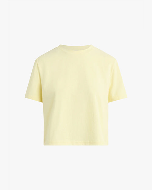 The frontside view of a light yellow short-sleeved t-shirt. The background is plain and white.