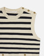 A sleeveless knitted top with horizontal black- and cream-colored stripes. The top has a round neckline with braided detailing and features gold buttons on the left shoulder and waistline. The brand label "FRAME" is visible at the back of the neckline.