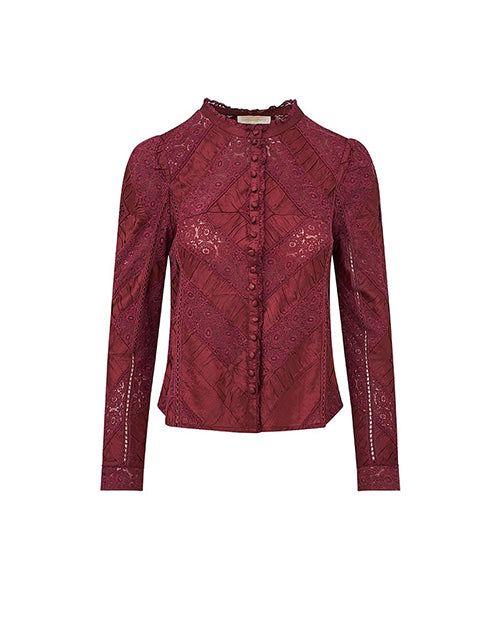 A long-sleeved, button-up maroon blouse with intricate floral and geometric patterns. The background is plain white.