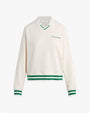 A white long-sleeve sweatshirt with green stripes on the cuffs and hem. The sweatshirt has a collar and a V-neck design, with text on the left chest area that reads "Favorite Daughter" in green. There is a rectangular white tag under the inner neckline.