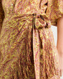Close-up of a patterned dress with a tie waist.