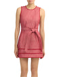 Model wearing a sleeveless red dress on a  white background
