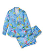 A blue long-sleeve button-down pajama shirt next to a folded pair of matching drawstring pants. The clothes are floating against a white backgrond.