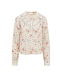 A long-sleeved, floral-patterned blouse with horizontal lace detailing and a lightly ribbed fabric. The blouse has a high neckline with ruffled edges and buttons down the front, with a pattern of small pink flowers and a lace trim at the cuffs. The background is plain white.