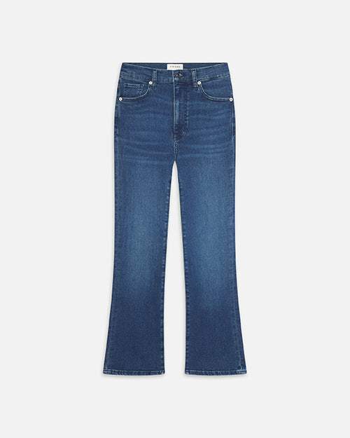 A frontal image of a pair of blue denim jeans, slightly flared at the bottom, with a faded look, particularly around the knees and thighs.