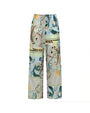A pair of wide-leg pants with an elastic waistband and drawstring. The pants feature a colorful paisley pattern with shades of blue, green, yellow, and beige.