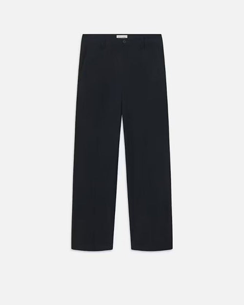 A pair of navy trousers with a white rectangular tag on the inner waistband. The pants are placed in front of a white background.