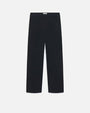 A pair of navy trousers with a white rectangular tag on the inner waistband. The pants are placed in front of a white background.