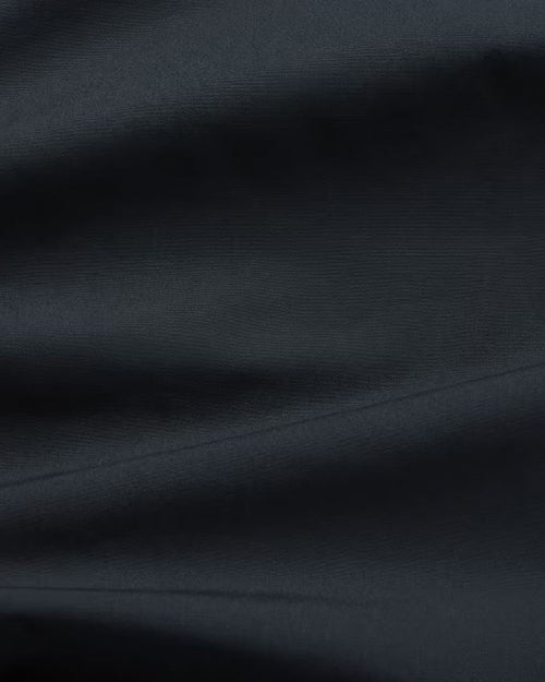 A close-up of soft navy fabric.