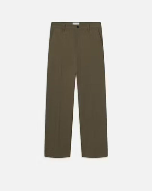 A pair of green trousers with a white rectangular tag on the inner waistline. The pants are placed in front of a white background.