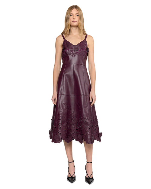 Woman wearing a burgundy dress with floral details on a white background