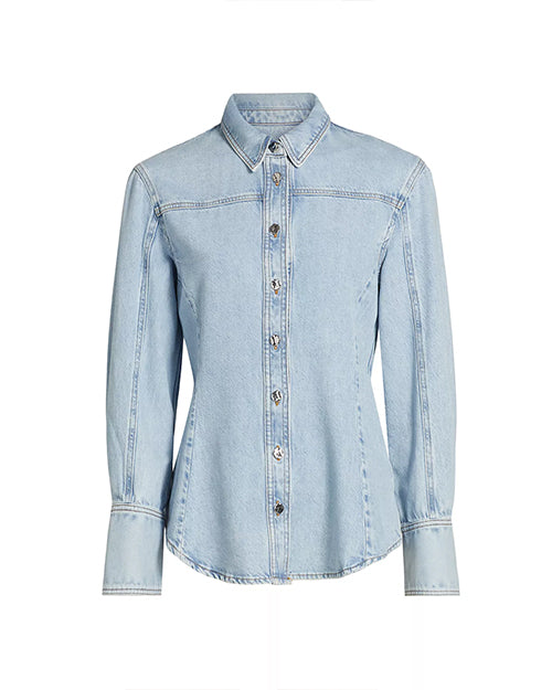 A light blue collared denim shirt with long sleeves and long wrist cuffs. The shirt features visible stitching along the seams and silver buttons. The background is plain white.