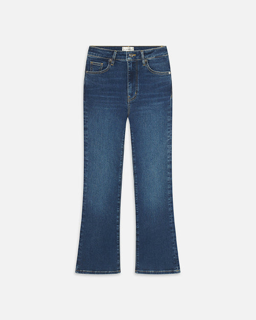 A pair of blue jeans with a slight fade and flared ends. The pants are placed against a white background.