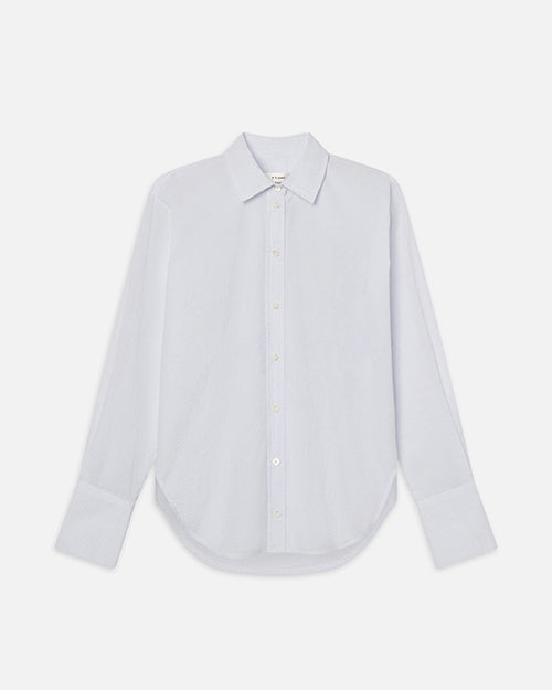 A white and light blue striped long-sleeve button-up shirt, placed in front of a white background.