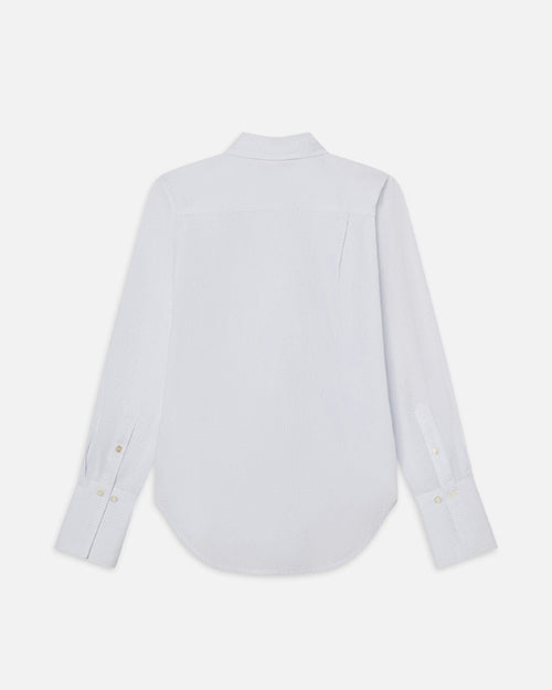 The backside view of a white and light blue striped long-sleeve button-up shirt. The shirt is placed in front of a white background.