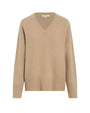 A beige V-neck sweater featuring thick wrist cuffs and a thick waistline with a ribbed design. The background is plain white.