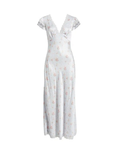 A long, light-blue dress featuring short sleeves with laced edging and a laced V-neckline. The dress has a floral pattern with small pink flowers and is placed against a white background.