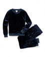 A navy-blue velvet long-sleeved pajama shirt next to a pair of matching folded drawstring pants. The background is plain white.