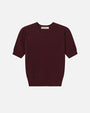 Flat lay of a short-sleeve textured knit top in deep burgundy with a ribbed hem and crew neckline, displayed against a white background.