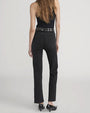 Back view of high-waisted black jeans with straight legs, paired with a black studded belt and black sleeveless top.