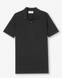 A black polo-shirt with a rectangular white tag in the inner neckline. The shirt is placed in front of a white background.