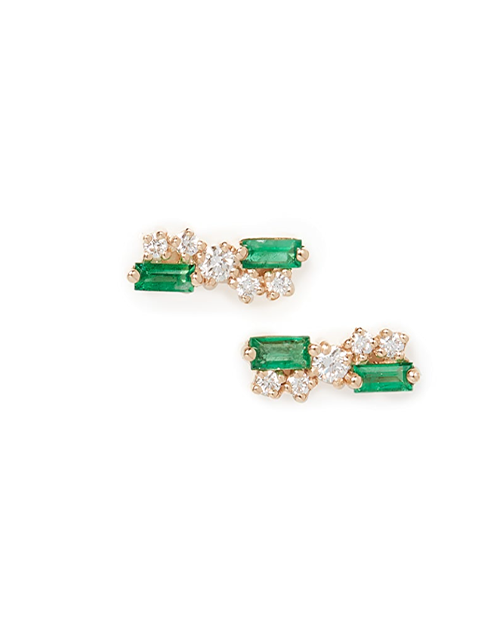 A pair of elegant gold earrings, each featuring two rectangular green gemstones surrounded by small round white gemstones. The background is plain white.