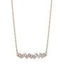 A rose gold chain necklace with baguette-cut diamonds aligned in row. The background is plain white.