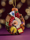 A festive Christmas ornament adorned with an array of food items, including pastries, fruits, and seasonal delicacies.