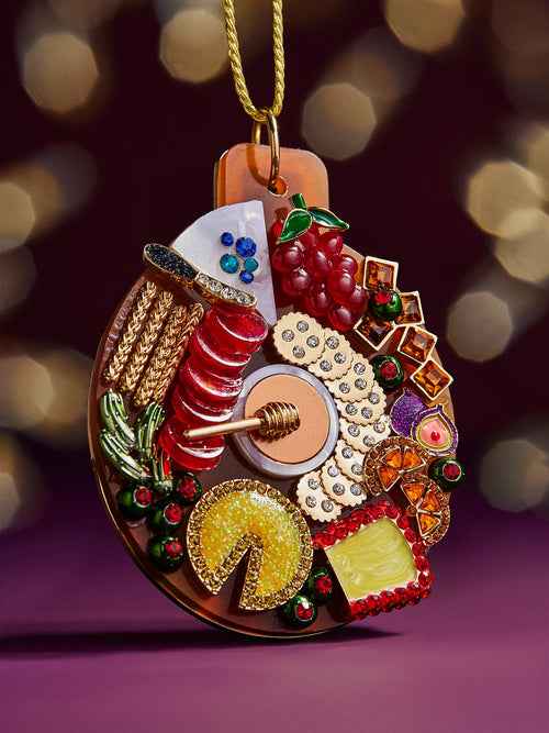A festive Christmas ornament adorned with an array of food items, including pastries, fruits, and seasonal delicacies.