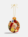 A Christmas ornament featuring an assortment of colorful food items, including fruits, sweets, and festive treats.