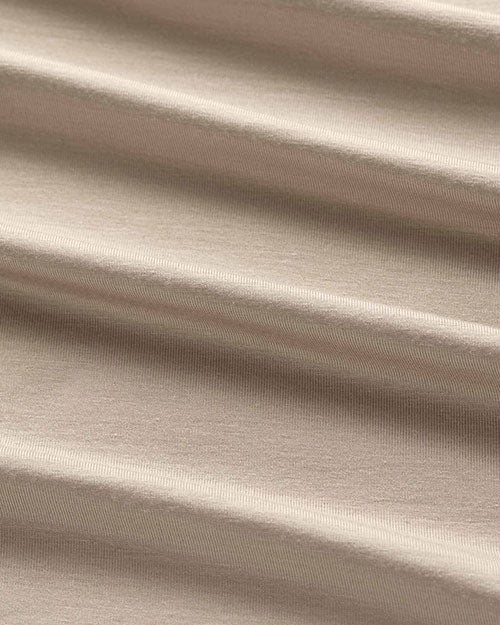 Close-up of a beige fabric, showcasing the texture of a men's t-shirt.