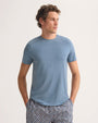 The model showcases a blue t-shirt paired with shorts.