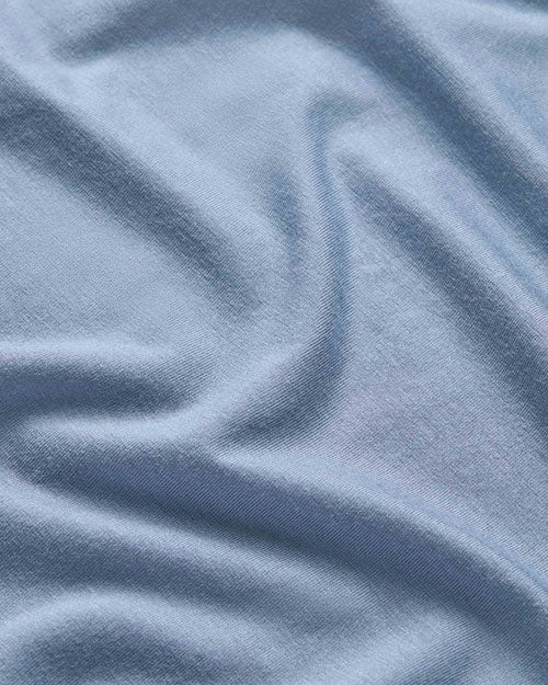  A piece of blue fabric showcasing the material of the shirt 