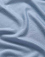  A piece of blue fabric showcasing the material of the shirt 