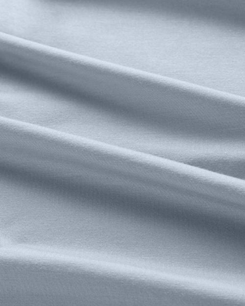  Light blue fabric with a folded edge, showcasing the soft, breathable texture of the Derek Rose Basel 23 T-shirt.