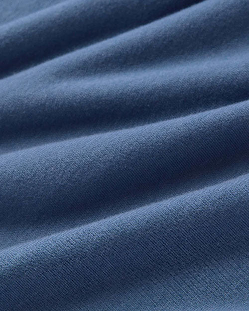 Close-up of a textured blue fabric, showcasing its rich color and intricate weave details.