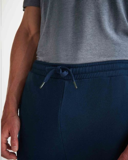 Up-close image of navy-blue joggers combined elastic and tie waistband 